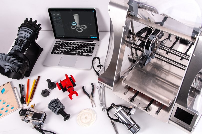 Ein 3D-Drucker, ein 3D-Modell und 3D-gedruckte Objekte
