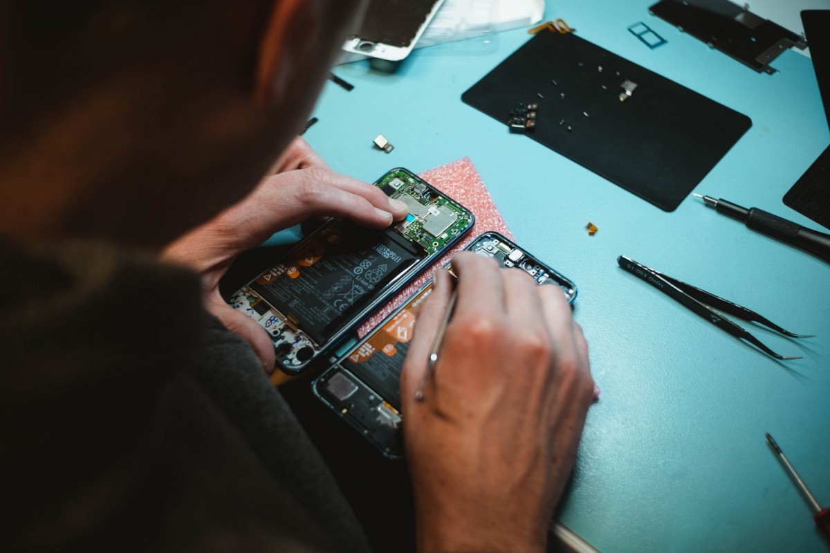 Image of a person repairing a smartphone